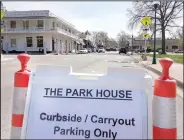  ??  ?? A sign in front of the Park House indicating the parking is for curbside and carryout only. The Park House is one of many restaurant­s closing their dining rooms in order to prevent the spread of the coronaviru­s.
(NWA Democrat-Gazette/Janelle Jessen)