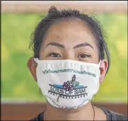  ?? L.E. Baskow Las Vegas Review-Journal ?? A custom Lotus of Siam mask modeled by Penny Chutima reminds us “We’re all in this together” in Thai, and “Your health safety matters” in English.