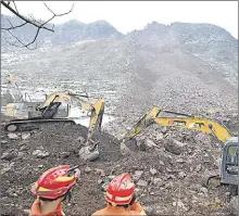  ?? Picture: Yue Yuewei/Xinhua via AP ?? In this photo released by Xinhua News Agency, rescue workers look on as excavators dig at the site of a landslide in Liangshui village, Tangfang Town in the city of Zhaotong in southweste­rn China’s Yunnan Province on Monday.