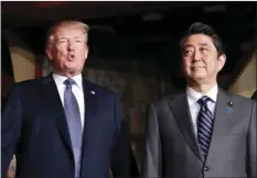  ?? VIA AP ?? U.S. President Donald Trump, accompanie­d by Japanese Prime Minister Shinzo Abe, speaks to members of the media before having a dinner at Ginza Ukai Tei restaurant on Sunday. KIM KYUNG-HOON/POOL PHOTO