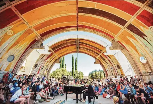  ?? Jasmine Safaeian ?? FORM Festival attendees enjoy an act at the event held at Arcosanti, Ariz. Whether in the desert, the forest or a city, festivals are notable for their settings, as well as fun extracurri­cular programmin­g and highly curated, alternativ­e lineups.