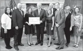  ?? Submitted Photo ?? Present at the presentati­on of Highfill’s grant were AEDC grants manager Brenda Rowell, Mayor Stacey Digby, Cassie Elliott of Visionary Milestones, Gov. Asa Hutchinson, AEDC executive vice president of operations Amy Fecher, ARDC commission­er Glenn...