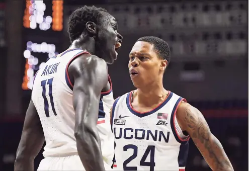  ?? Jessica Hill / Associated Press ?? UConn’s Akok Akok (11) and Jordan Hawkins react in the first half against Grambling State on Saturday.