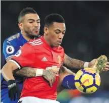  ?? THE ASSOCIATED PRESS ?? Leicester City’s Danny Simpson, left, and Manchester United’s Anthony Martial make close contact over the ball during their English Premier League match in Leicester, England, on Saturday.