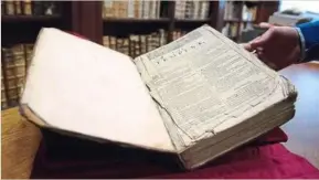  ??  ?? cordonnier carefully showing off the First Folio. The young librarian said he came across the book when he was selecting books for a forthcomin­g exhibition on historic links between the local region and England. Photo: AFP