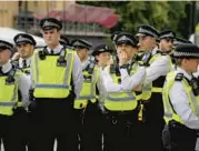  ?? VADIM GHIRDA/AP ?? Police gather Sunday in London, where more than 10,000 officers will be on duty Monday, officials say.
