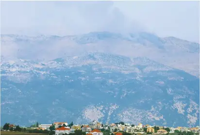  ?? (Karamallah Daher/Reuters) ?? SMOKE RISES from the Mount Dov area yesterday.