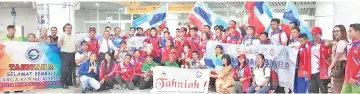  ??  ?? BEST EVER: Awang Damit (7th left with tie) hails Sabah’s achievemen­t at the XIX Para Sukma as extra-ordinary upon arrival at the Kota Kinabalu Internatio­nal Airport yesterday.