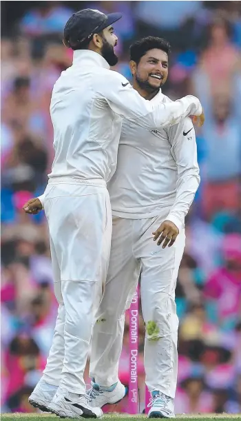  ?? Picture: AAP/Dan Himbrechts ?? Indian spinner Kuldeep Yadav (right) celebrates with captain Virat Kohli after taking the wicket of Australia’s Travis Head yesterday in the fourth Test at the SCG