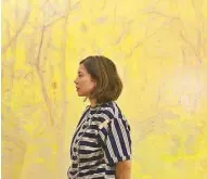  ??  ?? Melissa Echauz la O’ in front of her painting, “Big Tropics Yellow”