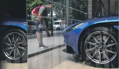  ?? AFP ?? An Aston Martin DB11 in a London showroom. The car maker is set to float on the LSE this year