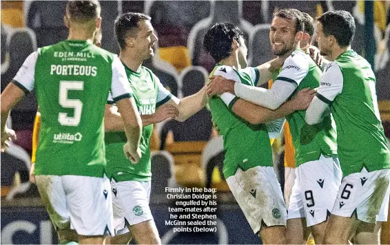  ??  ?? Firmly in the bag: Christian Doidge is engulfed by his team-mates after he and Stephen McGinn sealed the points (below)