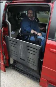  ??  ?? James Myers lowers the ramp leading from his modified Dodge van that, once he receives certificat­ion, will allow his to drive unassisted February 6, 2019.
