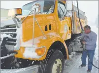  ??  ?? Middletown Public Works plow driver Joe Barone gasses up his truck in January.