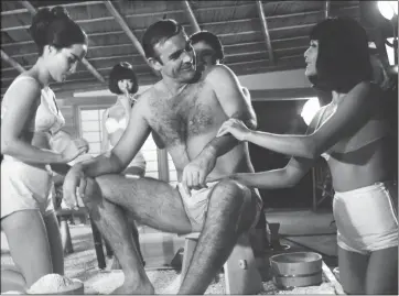  ?? THE ASSOCIATED PRESS ?? Scottish actor Sean Connery is given a Japanese bath during the filming of a scene in the James Bond film “You Only Live Twice” at Pinewood Studios near London in September of 1966.
