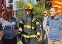  ?? (Courtesy) ?? CULTURE AND SPORT Minister Miri Regev (left) and Sderot Mayor Alon Davidi (right) visit firefighte­rs working in the southern town to keep a gas explosion, caused by a rocket falling, under control.