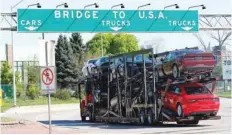  ?? — Reuters ?? A car hauler heading for Detroit, USA, drives on the lane to Ambassador Bridge in Windsor, in Ontario, Canada.