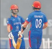  ?? HT PHOTO ?? ■
Afghanista­n’s Akram Alikhil (left) and Rahmat Shah celebrate their half centuries in the match against WI on Wednesday.