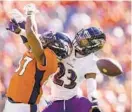  ?? JACK DEMPSEY/AP ?? Ravens cornerback Anthony Averett (23) breaks up a pass intended for Broncos tight end Noah Fant in the first half on Oct. 3 in Denver.