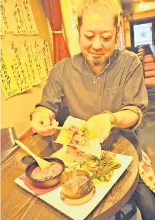  ?? — Photo by The Japan News ?? Owner-chef Yoshiyuki Uwajima prepares tacos using deer meat at ‘French Izakaya UWASHIMA’ in Sumida Ward, Tokyo.