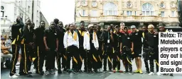  ??  ?? Relax: The Matabelela­nd players on a day out in London and signing up Bruce Grobbelaar