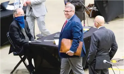  ?? TED SCHURTER/THE STATE JOURNAL-REGISTER VIA AP ?? State Rep. Darren Bailey, R-Xenia, is escorted Wednesday from the Bank of Springfiel­d Center.