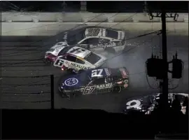  ?? CHRIS O’MEARA — THE ASSOCIATED PRESS ?? Travis Pastrana (67) Brad Keselowski (6) and Aric Almirola (10) crash during the NASCAR Daytona 500 on Sunday.