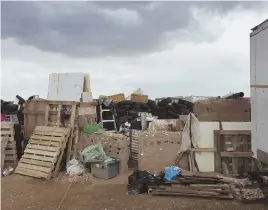  ?? PHOTO BY TAOS COUNTY SHERIFF'S OFFICE VIA AP; AP PHOTO, BELOW ?? THE SCENE: This photo released by Taos County Sheriff’s Office shows a rural compound where the remains of a boy were found in Amalia, N.M. Below, a ‘no trespassin­g’ sign outside the location.