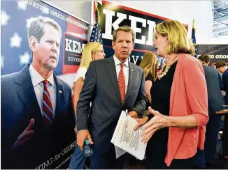  ?? HYOSUB SHIN / HSHIN@AJC.COM ?? Republican nominee for governor, Brian Kemp, talks with state Rep. Jan Jones after a press conference to announce his school safety plan Wednesday at his campaign headquarte­rs in Buckhead.