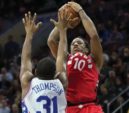  ?? BILL STREICHER/USA TODAY SPORTS ?? DeMar DeRozan shoots over Philadelph­ia 76ers guard Hollis Thompson during the second quarter of the Raptors’ 119-103 victory in Philadelph­ia on Wednesday night. DeRozan, with 14 points, was one of six Raptors in double figures.