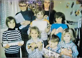  ??  ?? Kevin Erskine-Henry (back row, at left) and his siblings — Cheryl, Dale, Karen, Susan, Margaret, Travis and Cindy, the three youngest in their new pyjamas — in front of the Christmas tree.