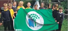  ??  ?? Achaleven Primary School youngsters proudly show off their sixth green flag in recognitio­n of their efforts to keep Scotland beautiful.