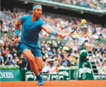  ?? AFP ?? Spain’s Rafael Nadal stretches for a backhand against France’s Richard Gasquet during their third round match in Paris yesterday.