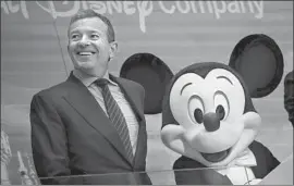  ?? Drew Angerer Getty Images ?? WALT DISNEY CO. Chairman and CEO Bob Iger will remain in his post — with a pay increase — at the request of both Disney’s board and Fox, the company said.