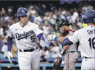  ?? Marcio Jose Sanchez Associated Press ?? FREDDIE FREEMAN continued his hot streak at the plate with a first-inning solo home run to get the Dodgers off to a good start against the Giants to open the second half of the season.