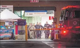  ?? Patrick Smith For The Times ?? AUTHORITIE­S respond to the scene of a shooting Friday night at the Costco on McKinley Street in Corona. One man was killed; two of his relatives were hurt.