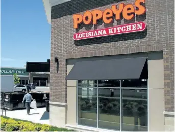  ?? DOUG IVES/THE CANADIAN PRESS ?? A Popeyes Louisiana Kitchen restaurant in Bowmanvill­e, Ont., on June 3, 2017. Restaurant Brands Internatio­nal
Inc., which owns Popeyes and Tim Hortons, reported a better-than-expected profit for its fourth quarter as revenue improved more than 10 per...