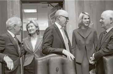  ?? Jacquelyn Martin / Associated Press ?? Sen. Bob Corker, R-Tenn., left, welcomes Kay Bailey Hutchison at the start of her nomination hearing as NATO ambassador Thursday in Washington. Other ambassador nominees, New York Jets owner Woody Johnson, to the United Kingdom, and Kelly Knight Craft,...