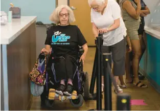  ?? RICK KINTZEL/THE MORNING CALL ?? Susan Schaffer maneuvers her wheelchair July 24 at the Udder Bar in Allentown, where she talked with customers about the struggles that people with disabiliti­es face.