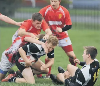  ??  ?? Houghton (black and white) battle to victory against Seaham on Saturday. Pictures by Tim Richardson.