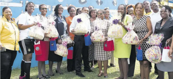 ??  ?? Teachers at Spring Gardens All Age School receiving baskets from Best Dressed Chicken representa­tives.
