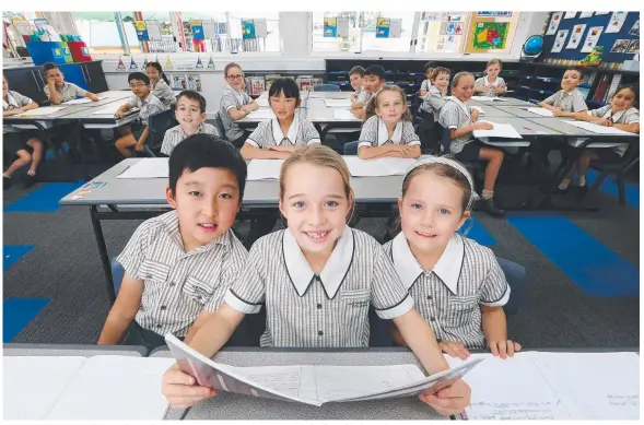  ?? Picture: GLENN HAMPSON ?? Year 3 A B Paterson College students Elie Kim, Jasmine Morris and Teegan Mitchell, all aged 8, have plenty to smile about.