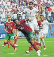  ?? REUTERS ?? Morocco's Aziz Bouhaddouz (No 20) scored an owngoal to hand Iran full points in their World Cup Group B opener on Friday.