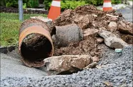  ??  ?? A broken water main pipe removed from underneath Green Street sits in a pile of debris on Friday in Saratoga Springs.