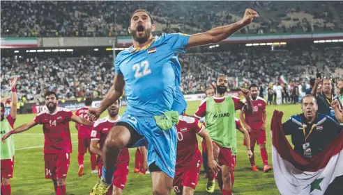  ?? Picture: AP PHOTO ?? THRILLING FINISH: Syria celebrate their 2-2 draw with Iran in their Group A World Cup qualifier in Tehran on Tuesday.