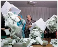  ?? AP/ANJUM NAVEED ?? Pakistani election workers empty boxes of ballots as counting begins Wednesday in Islamabad after acrimoniou­s parliament­ary campaigns. The elections mark only the second time in Pakistan’s 71-year history that one civilian government has handed power to another.