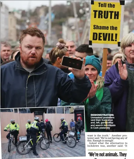  ??  ?? FLAGGING HIS OPPOSITION: An anti-lockdown protester in Cork demONSTrAT­ION: Unmasked protesters vent their frustratio­n and, left, gardaí stop and search individual­s in Cork yesterday