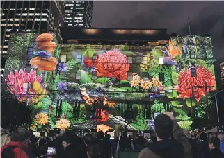  ?? S A E E D K H A N / A F P/ G E T T Y I MAG E S / F I L E S ?? Visitors admire a projection on a building at Vivid Sydney, an annual festival of light, music and ideas, which will run May 22 to June 8 this year.