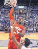  ?? JASON BEAN/THE RENO GAZETTE VIA AP ?? New Mexico’s Sam Logwood shoots over Nevada’s Hallice Cooke during the Lobos’ 77-74 defeat in Mountain West Conference play Saturday.