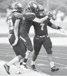  ?? KEN KOONS/BALTIMORE SUN MEDIA GROUP ?? From left, Westminste­r's Tavain Montgomery and Ryan Clatterbuc­k celebrate with Jaden Louis after Louis ran for a touchdown against Urbana.